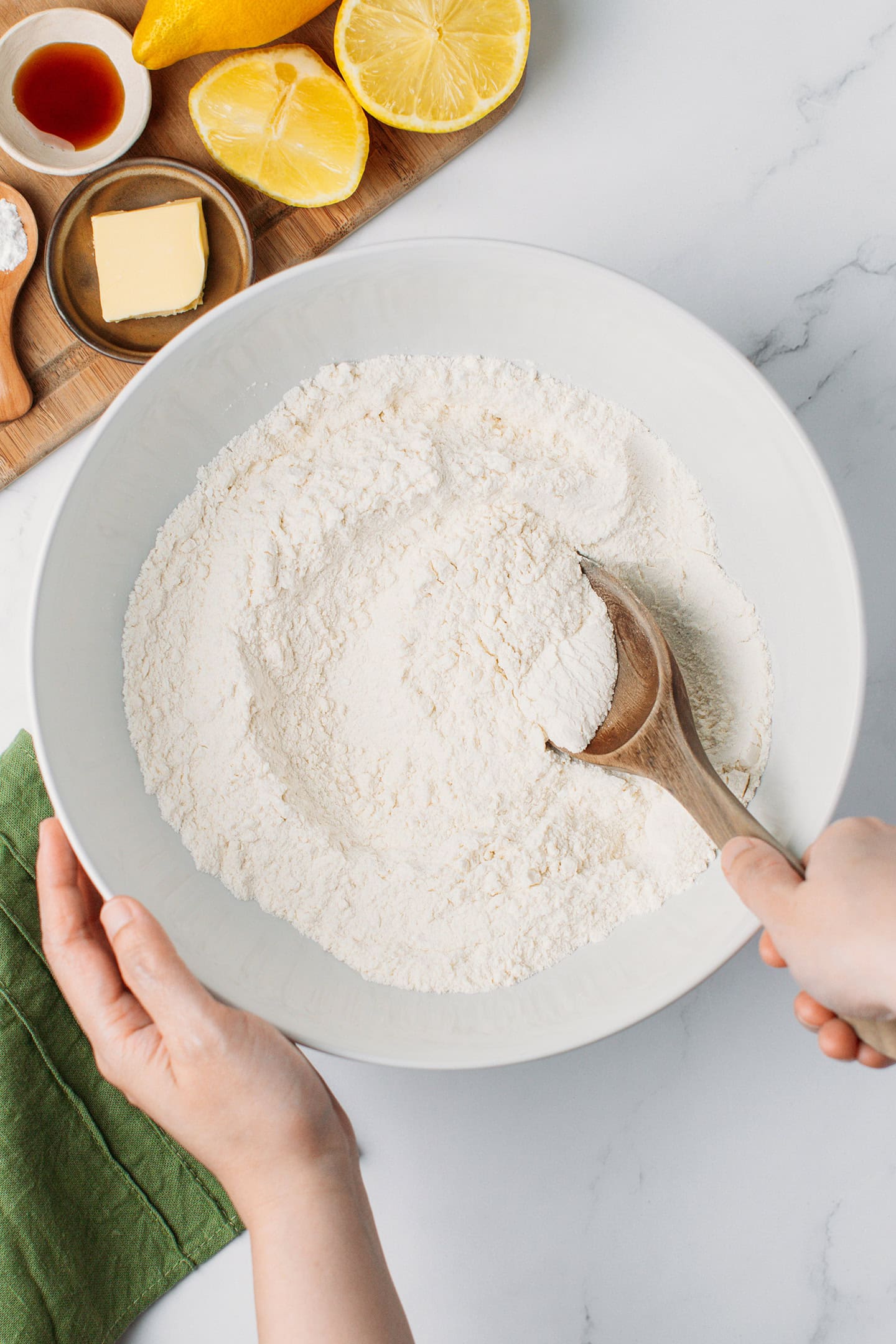 Mixing flour and baking powder in a bowl.