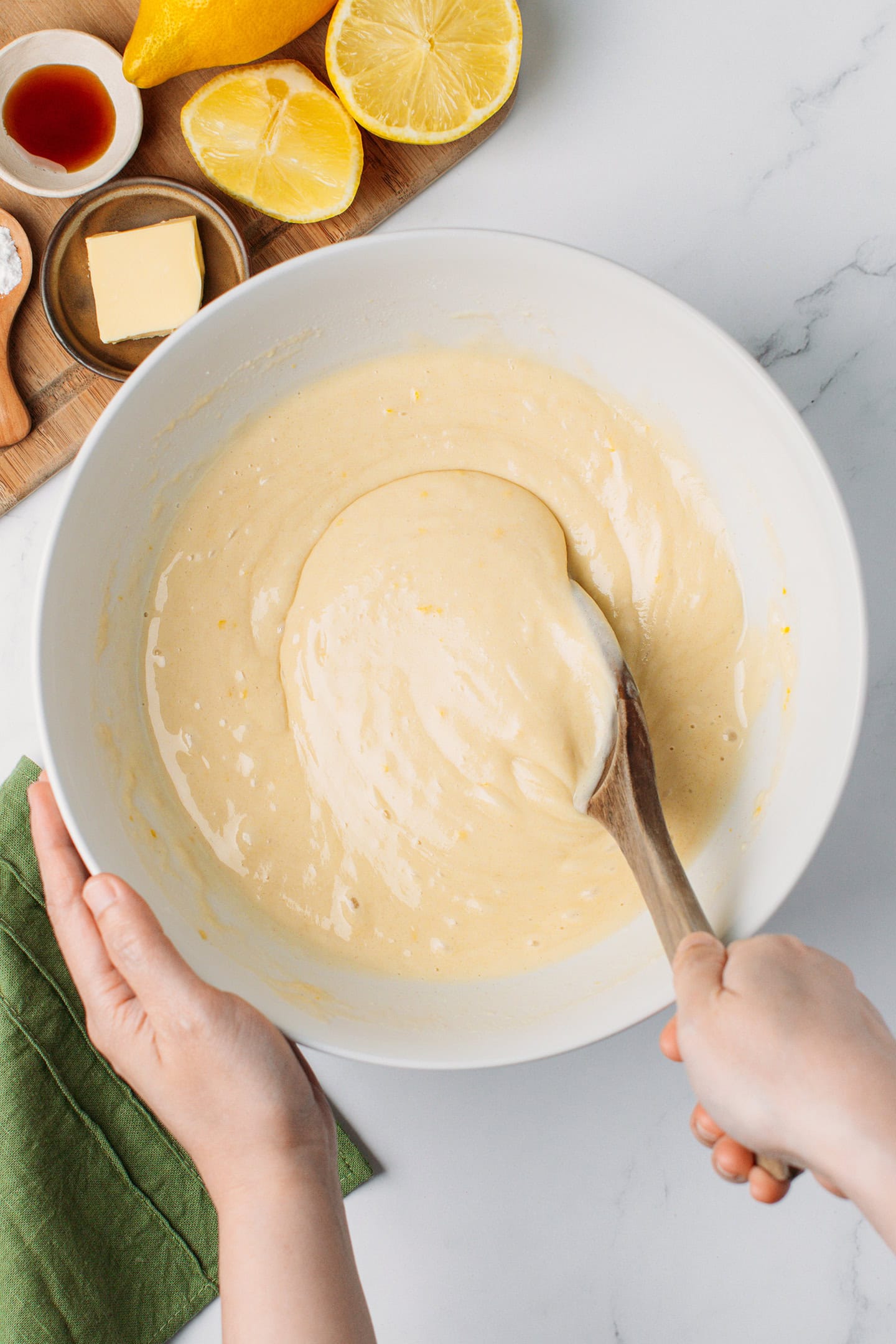 Mixing lemon cake batter in a bowl.