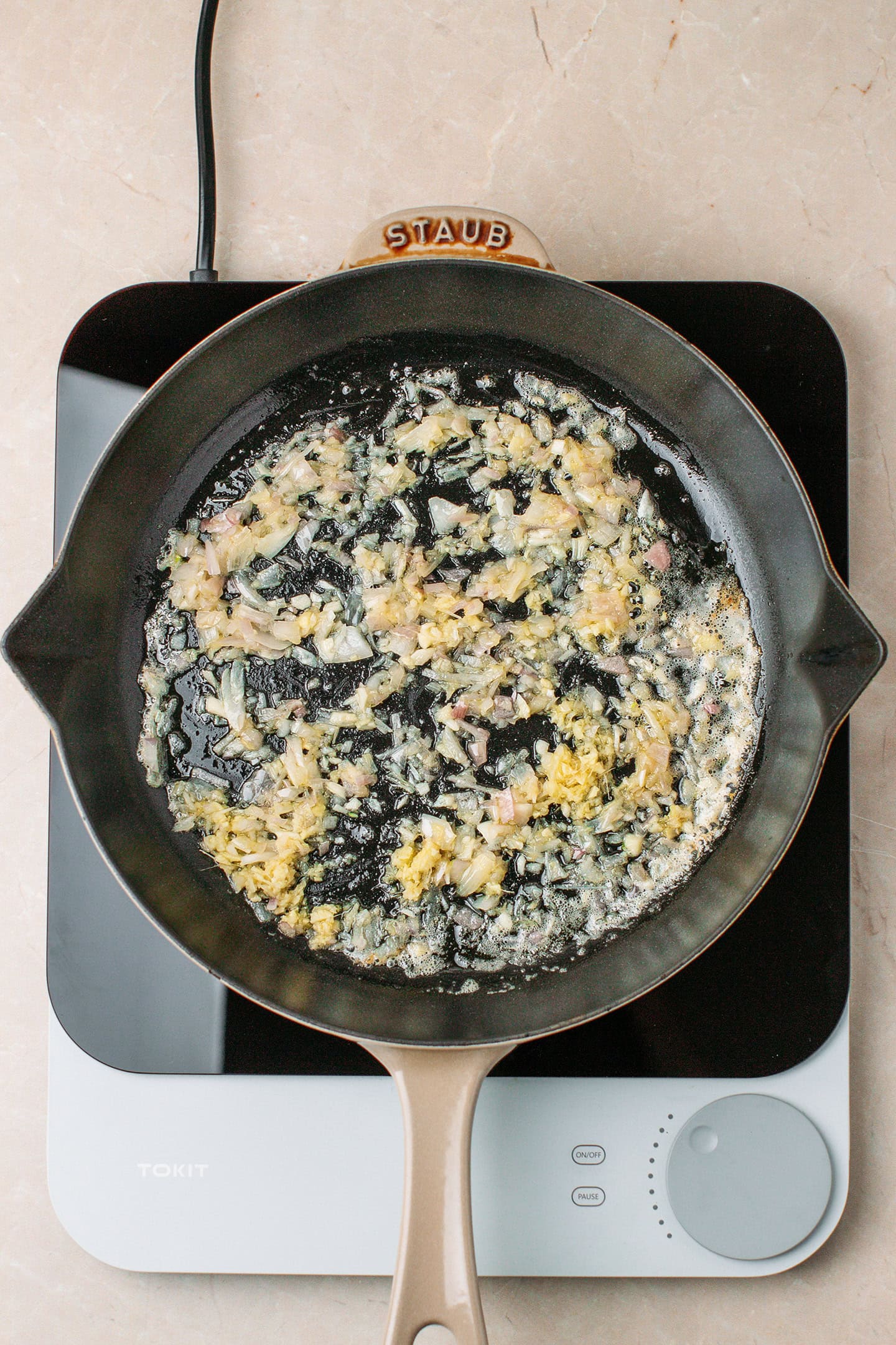Minced garlic, shallot, and ginger in a skillet.