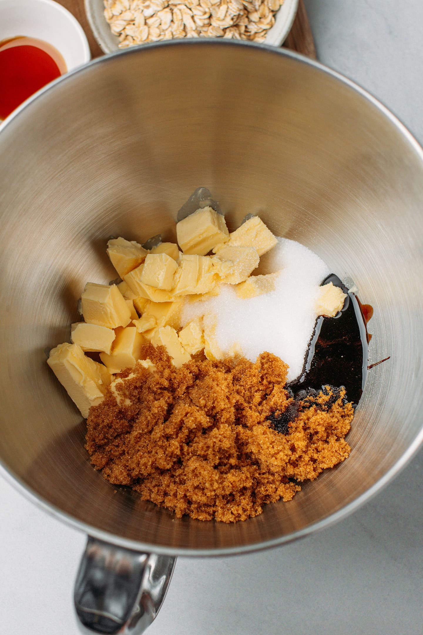 Diced butter, light brown sugar, sugar, and molasses in a bowl.
