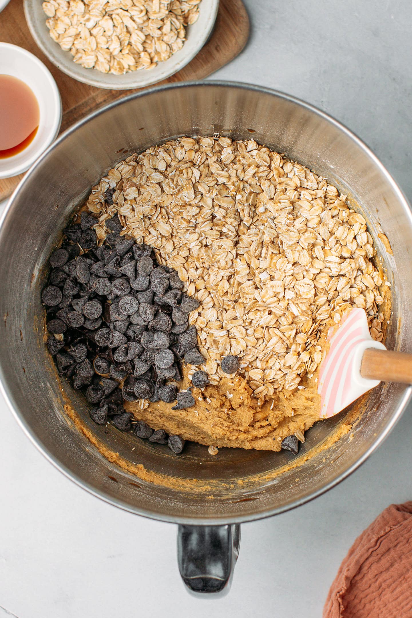 Cookie dough, rolled oats, and chocolate chips in a bowl.