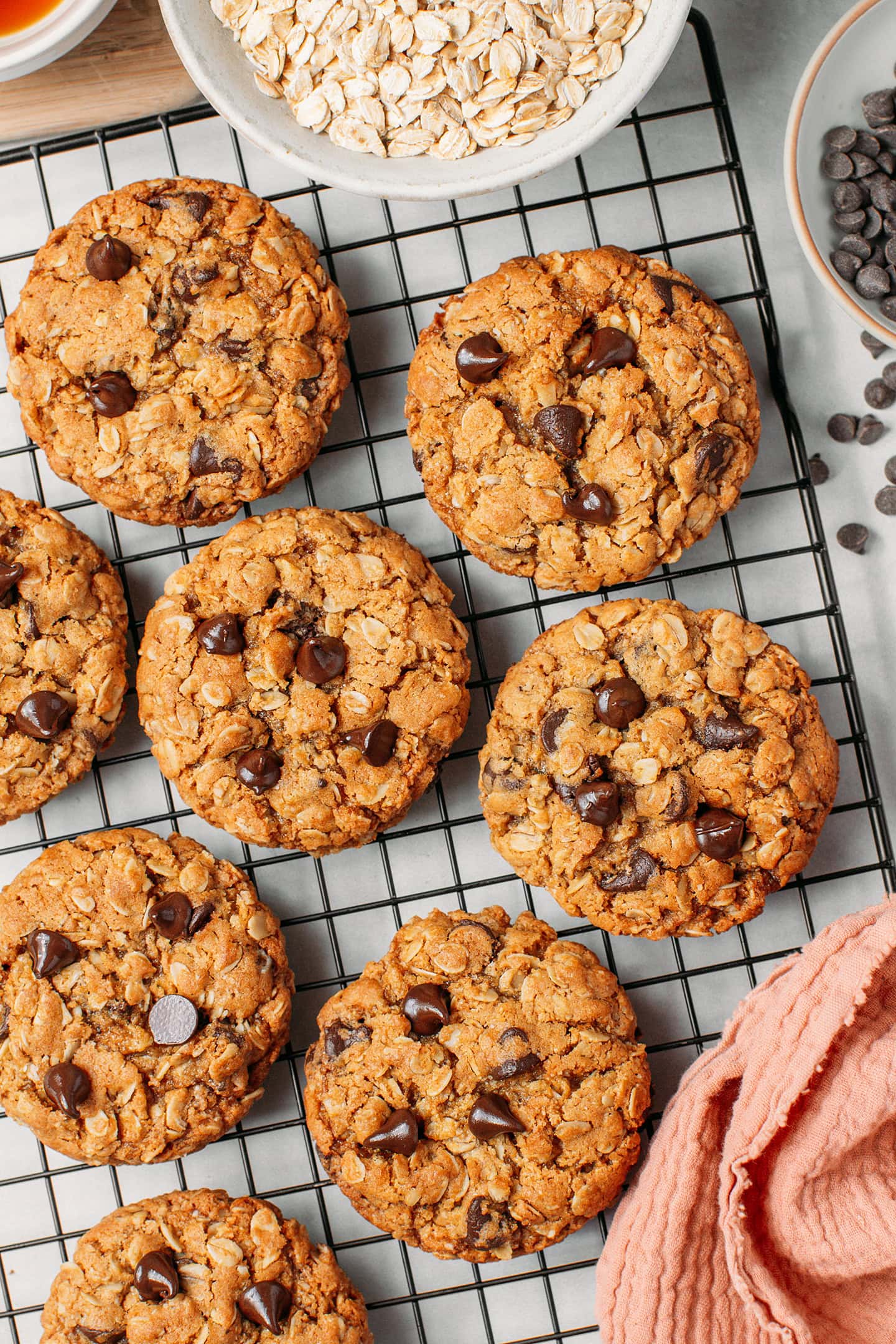 Oatmeal chocolate chip cookies on a cooling rack.