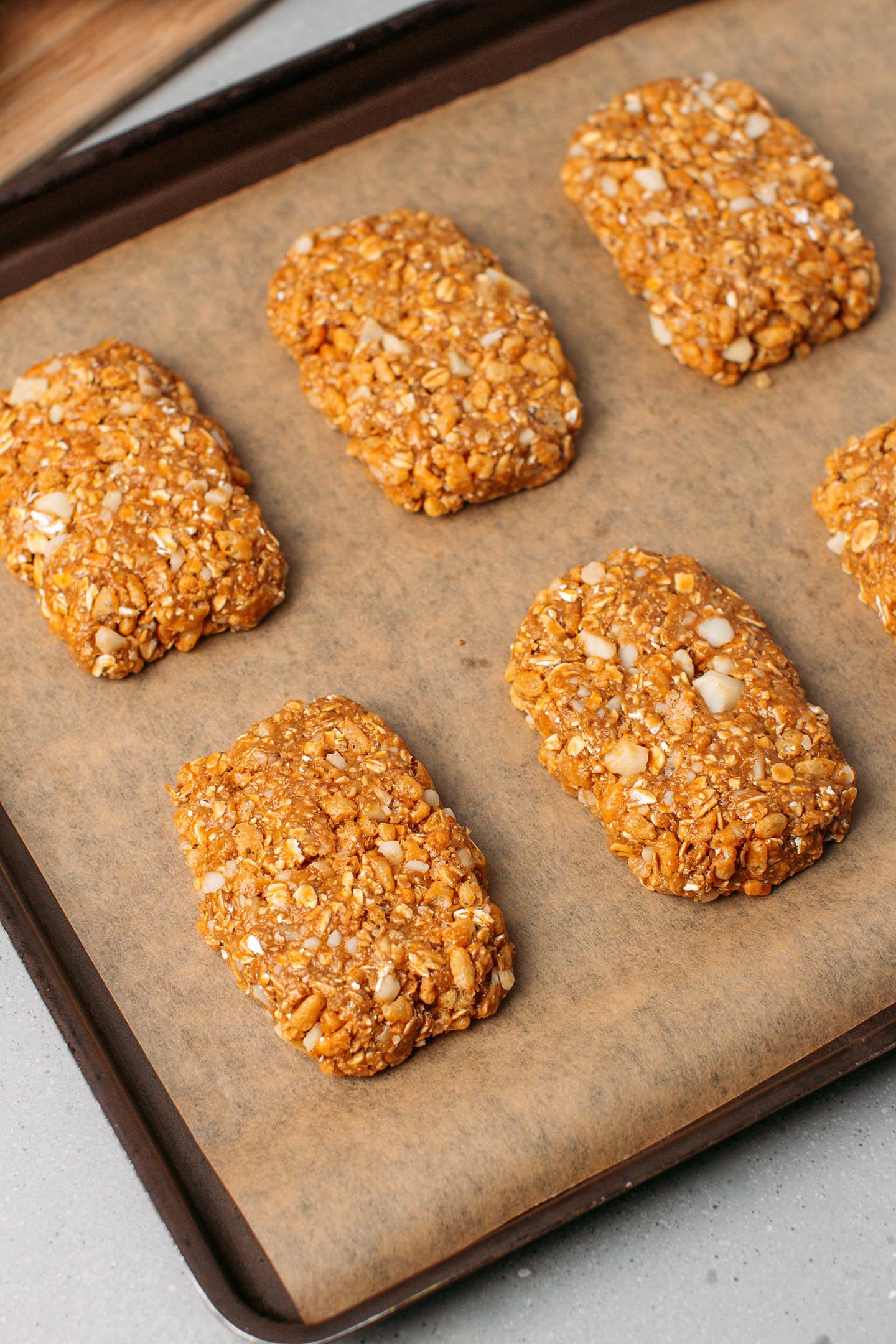 Six homemade granola bars on a baking sheet.