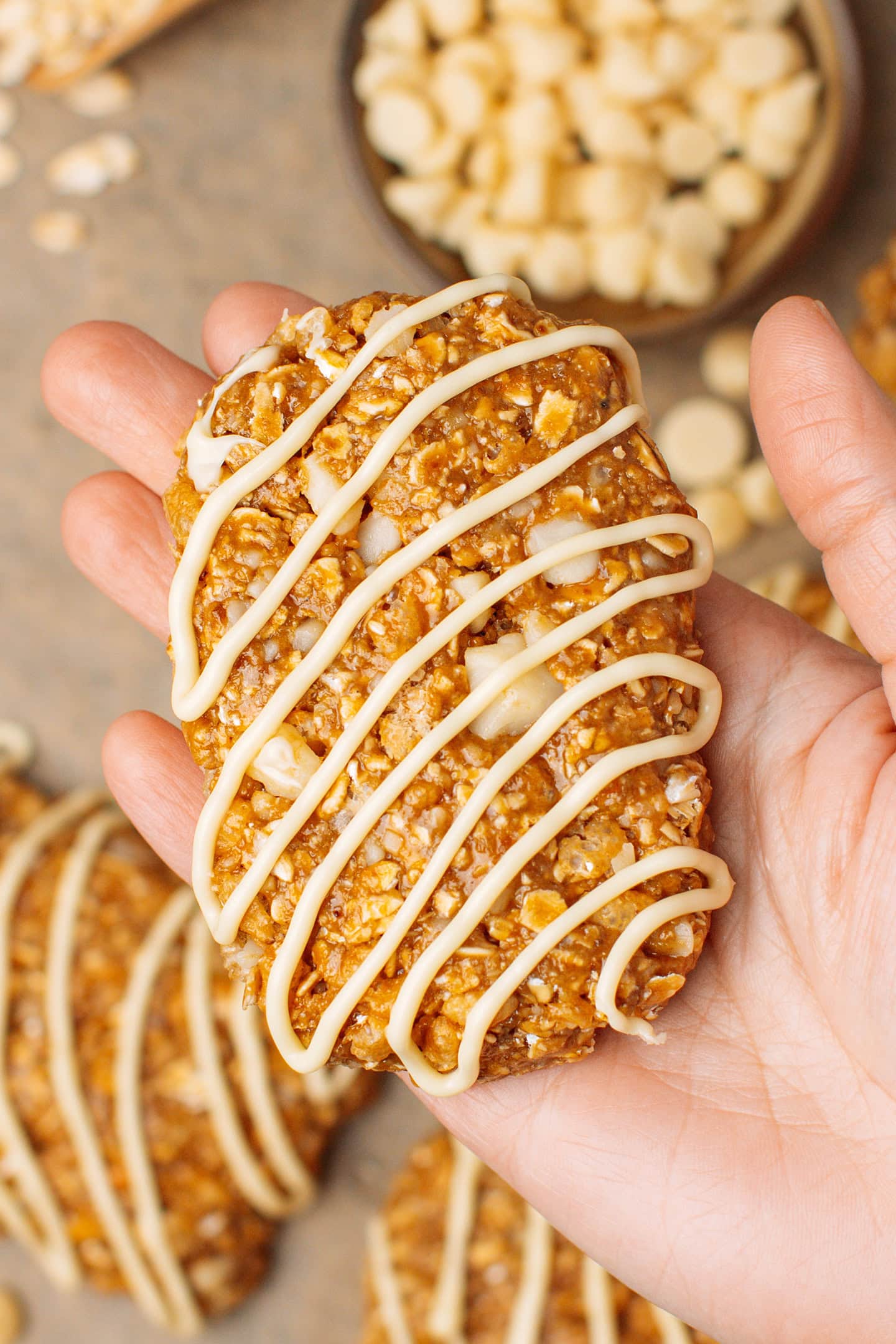 Holding a homemade Clif bar drizzled with vegan white chocolate.