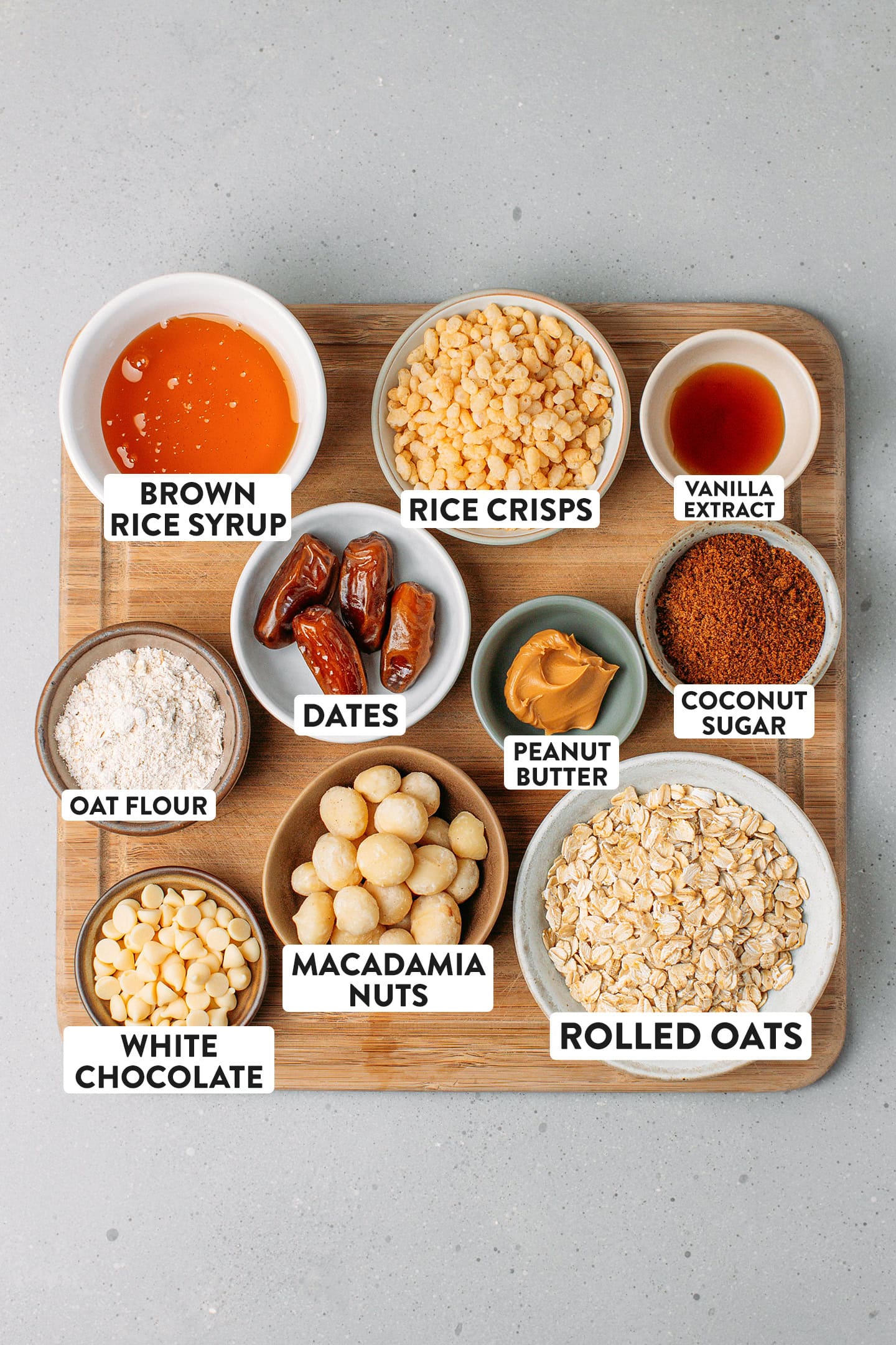 Ingredients like brown rice syrup, rice crisps, rolled oats, and macadamia nuts.