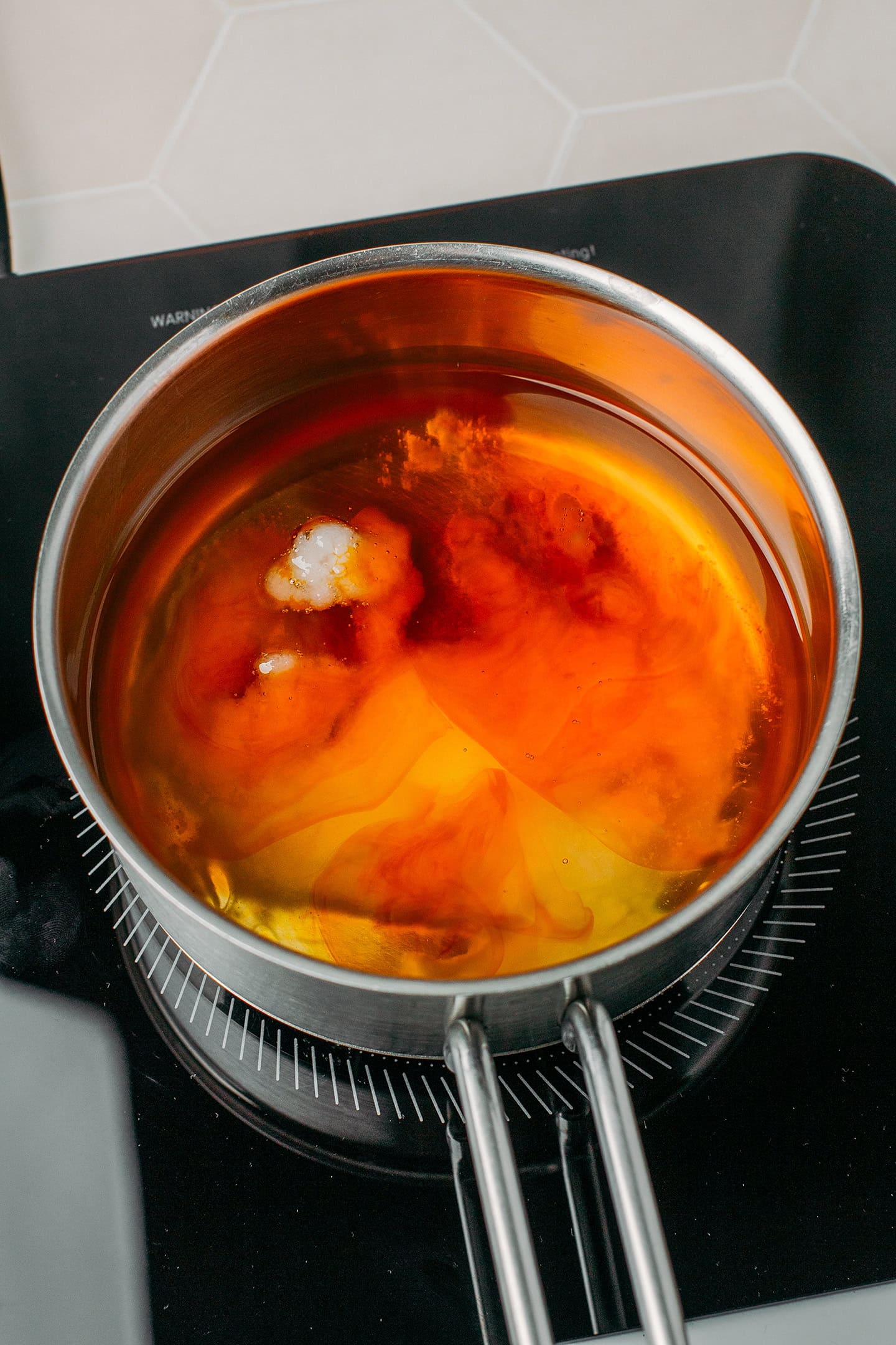 Melted coconut oil and butter flavoring in a saucepan.
