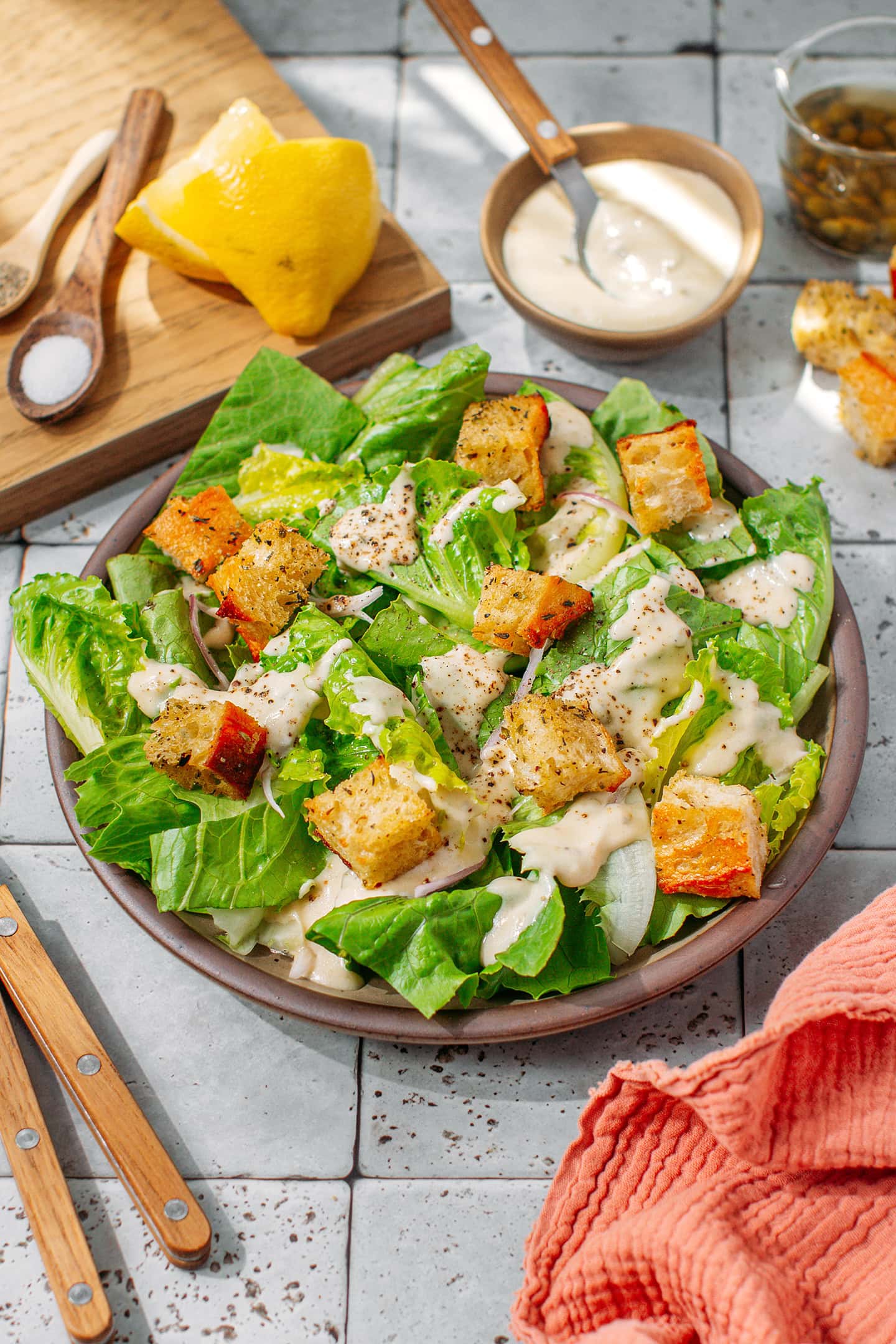 Vegan Caesar salad with croutons on a brown plate.
