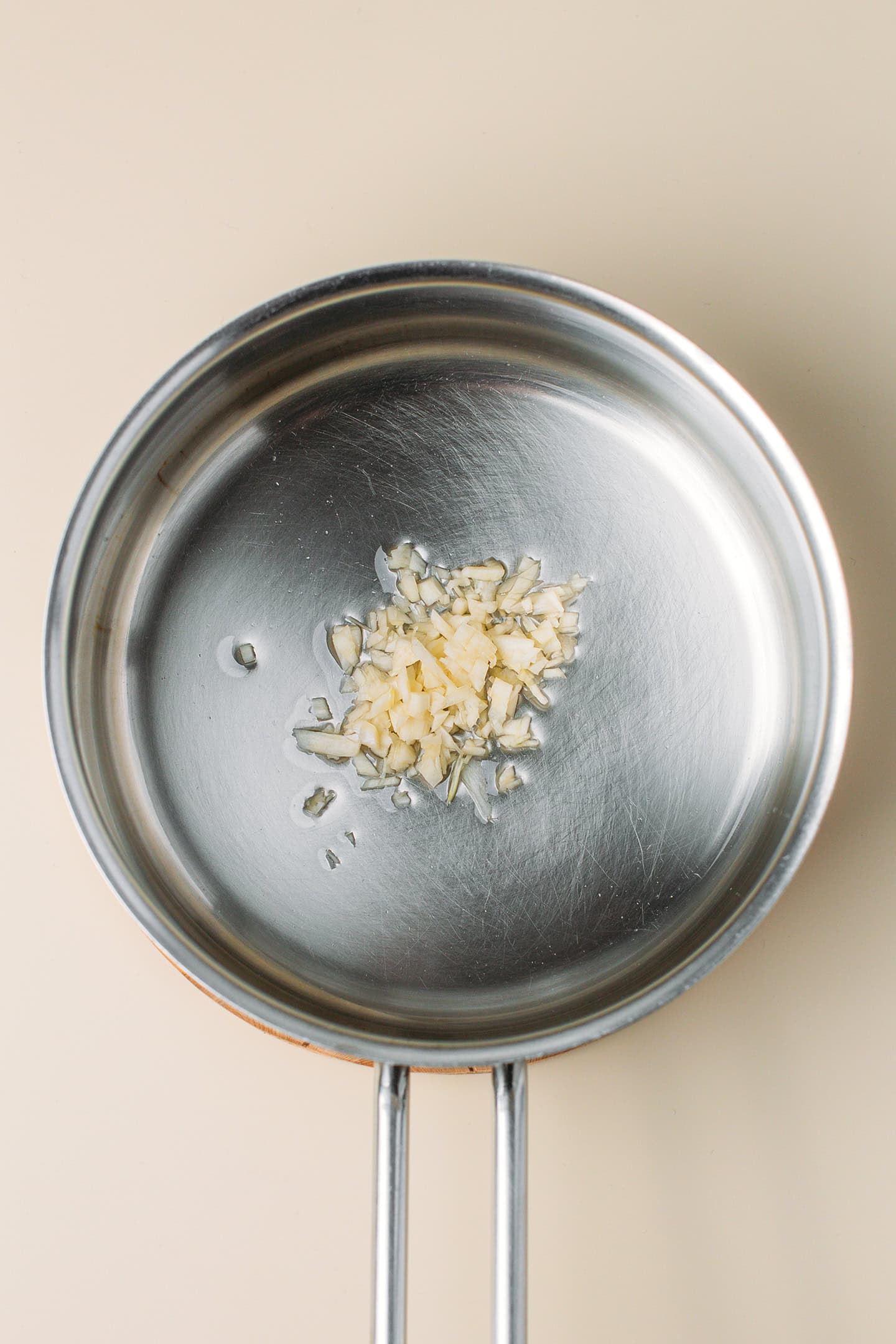 Minced garlic and oil in a saucepan.
