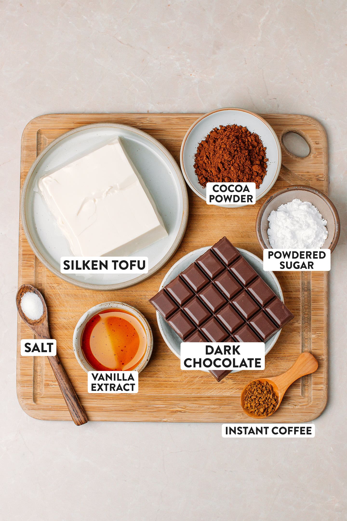 Ingredients like silken tofu, dark chocolate, powdered sugar, and cocoa powder.