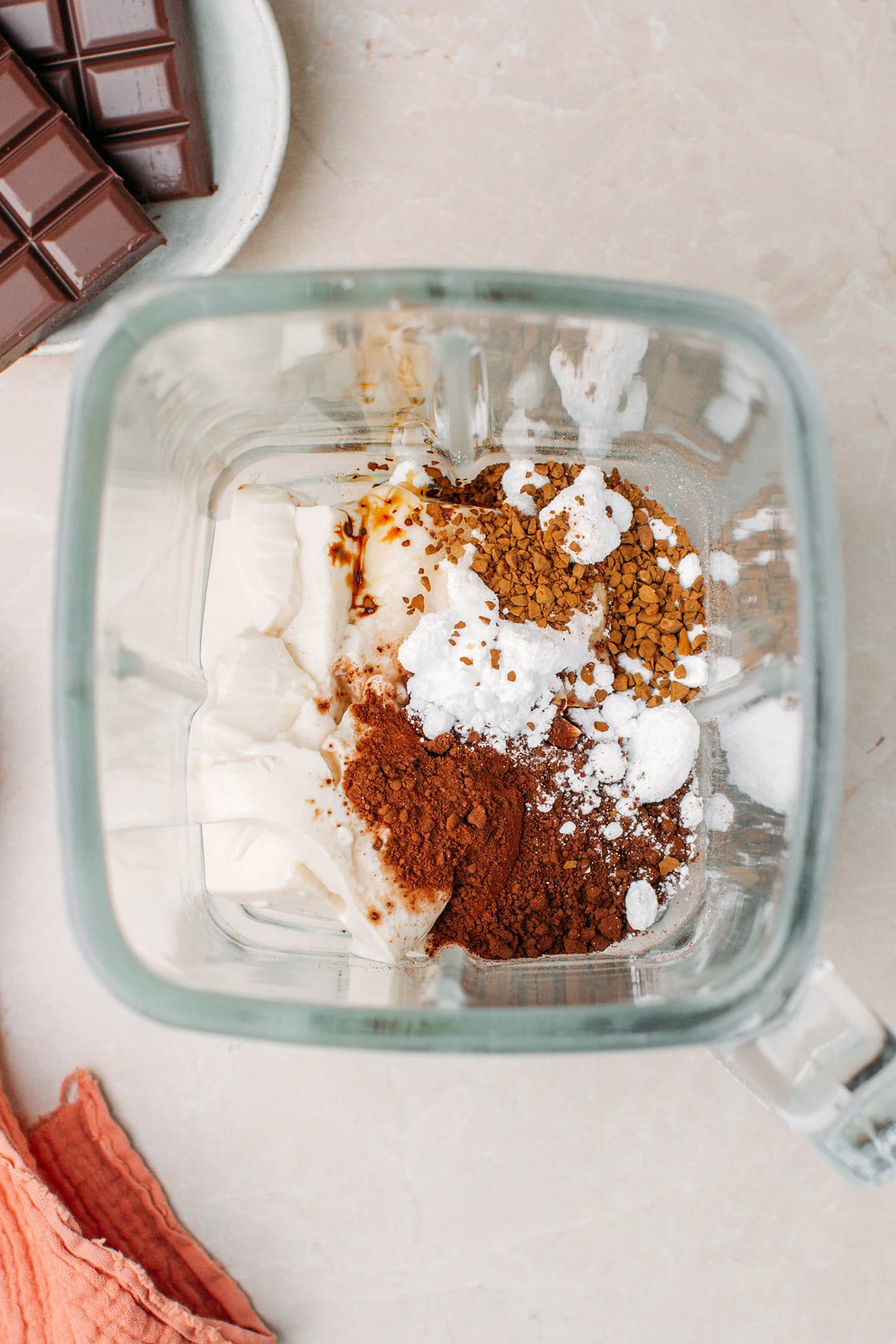 Silken tofu, cocoa powder, instant coffee, and powdered sugar in a blender.