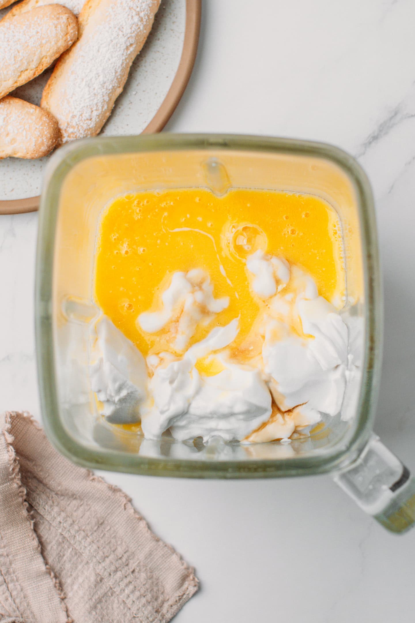 Coconut cream, melted vegan butter, and powdered sugar in a blender.