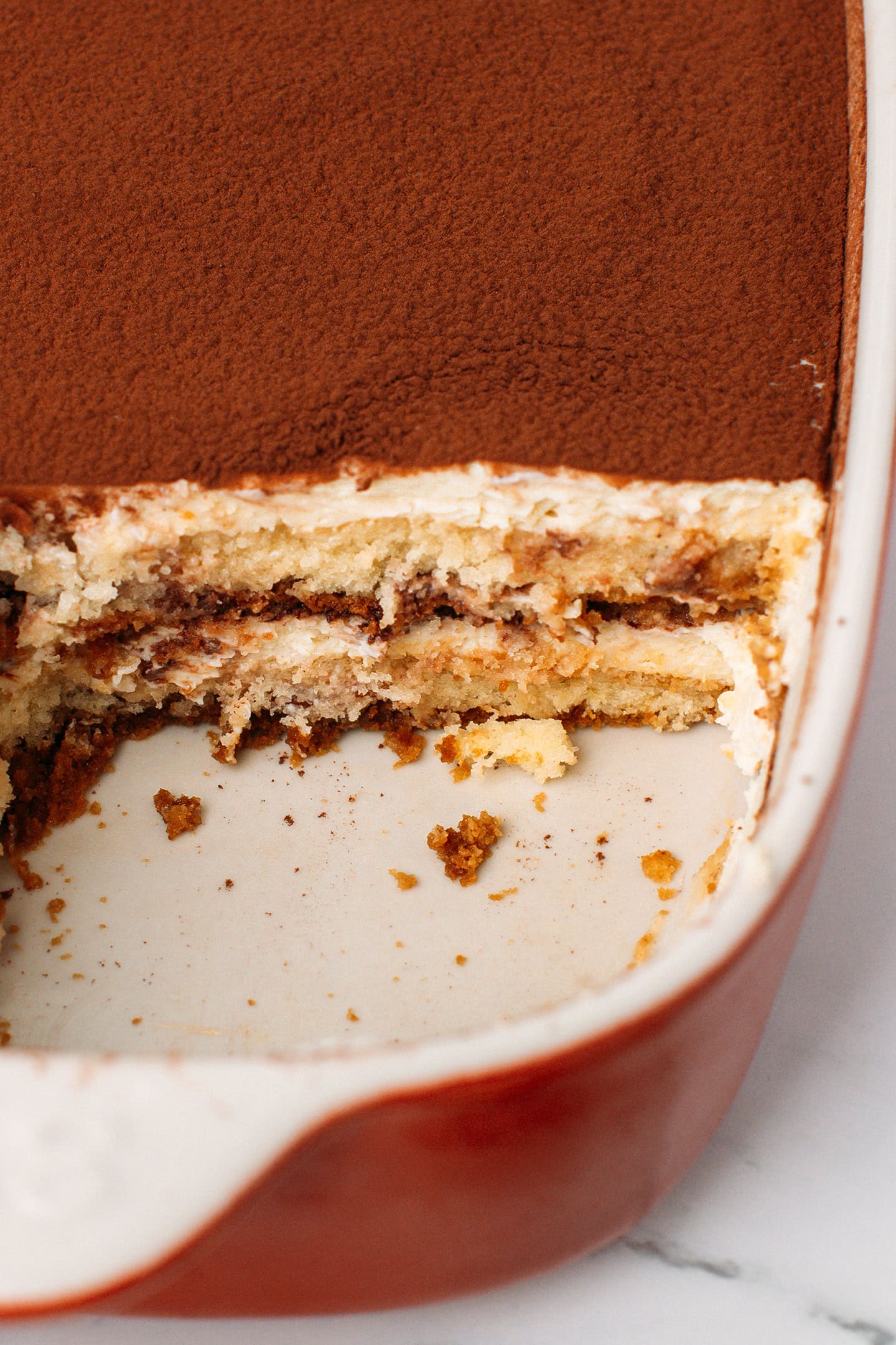 Close-up of vegan tiramisu inside a baking dish.