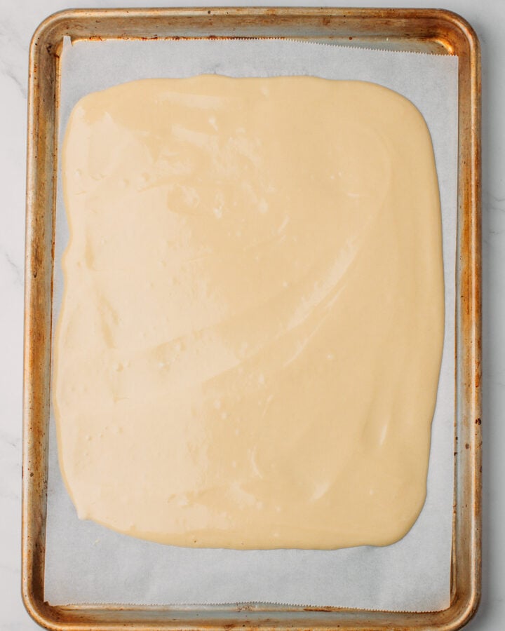 Unbaked sponge cake on a baking sheet.