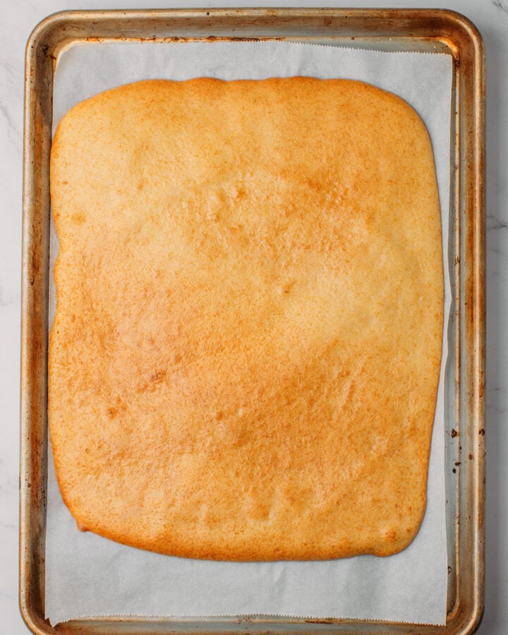 Baked sponge cake on a baking sheet.