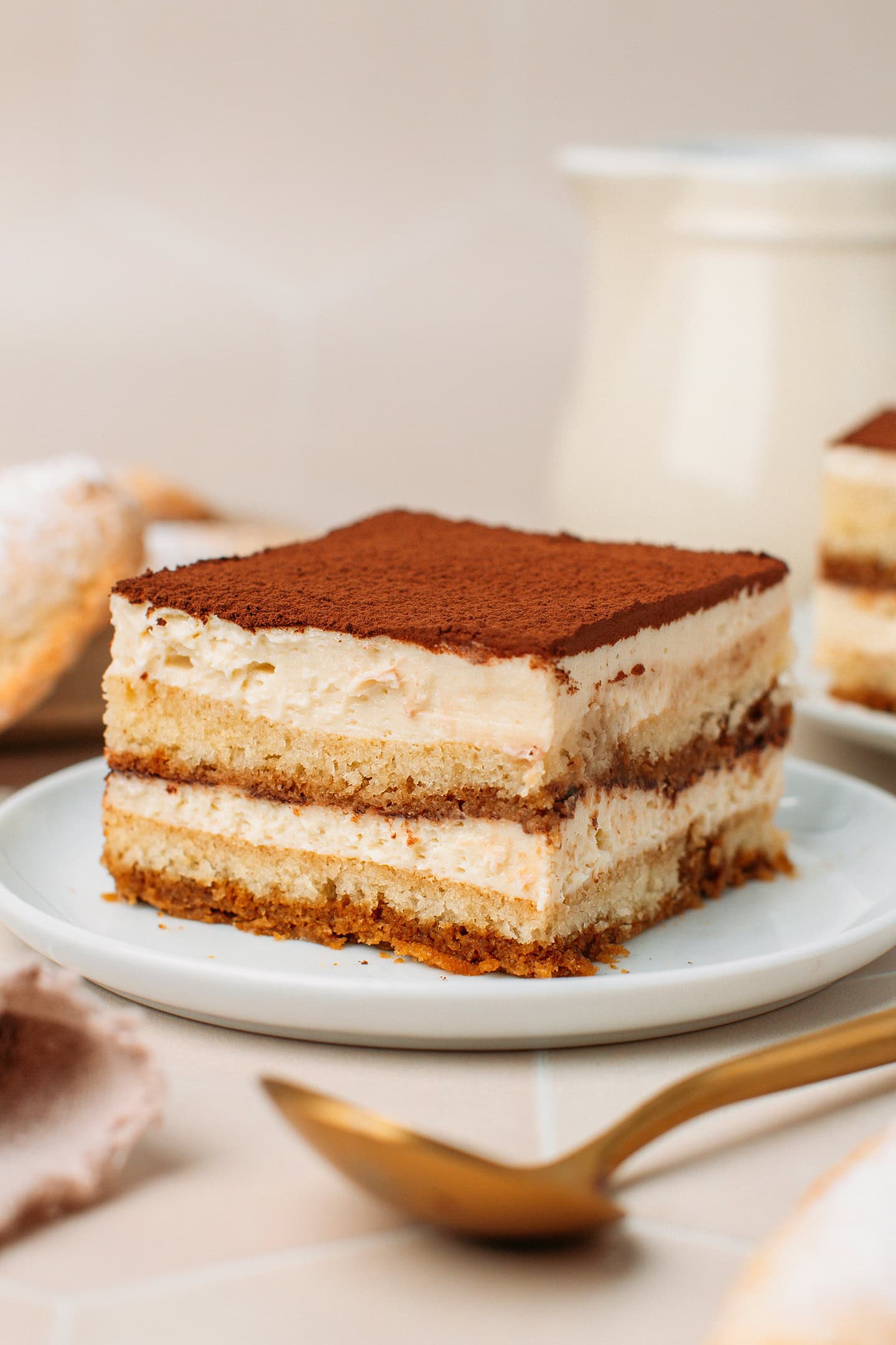 Slice of vegan tiramisu on a white plate.