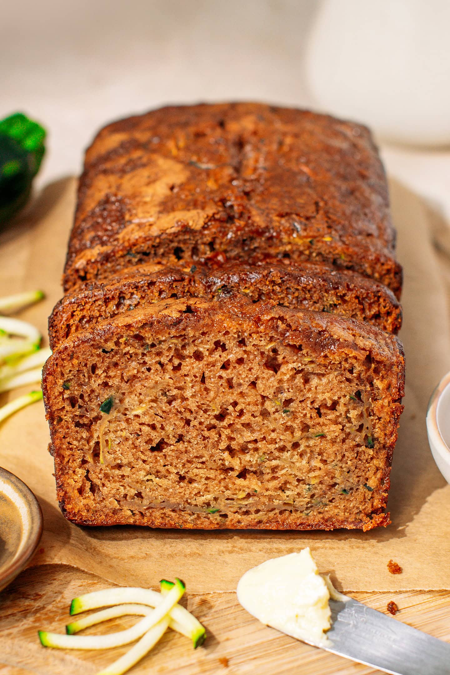 Whole zucchini bread on a cutting board.