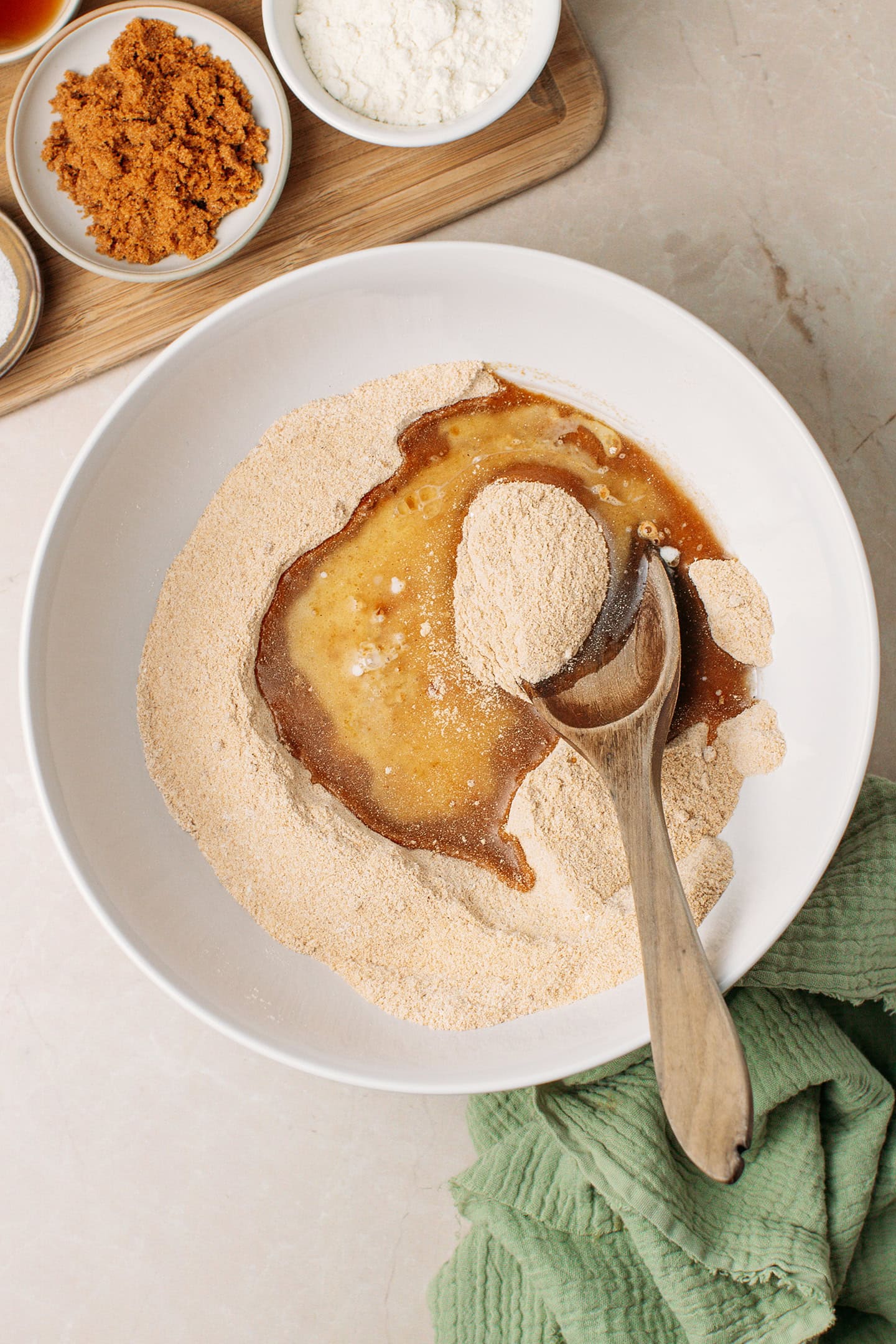 Flour, sugar, oil, and milk in a mixing bowl.