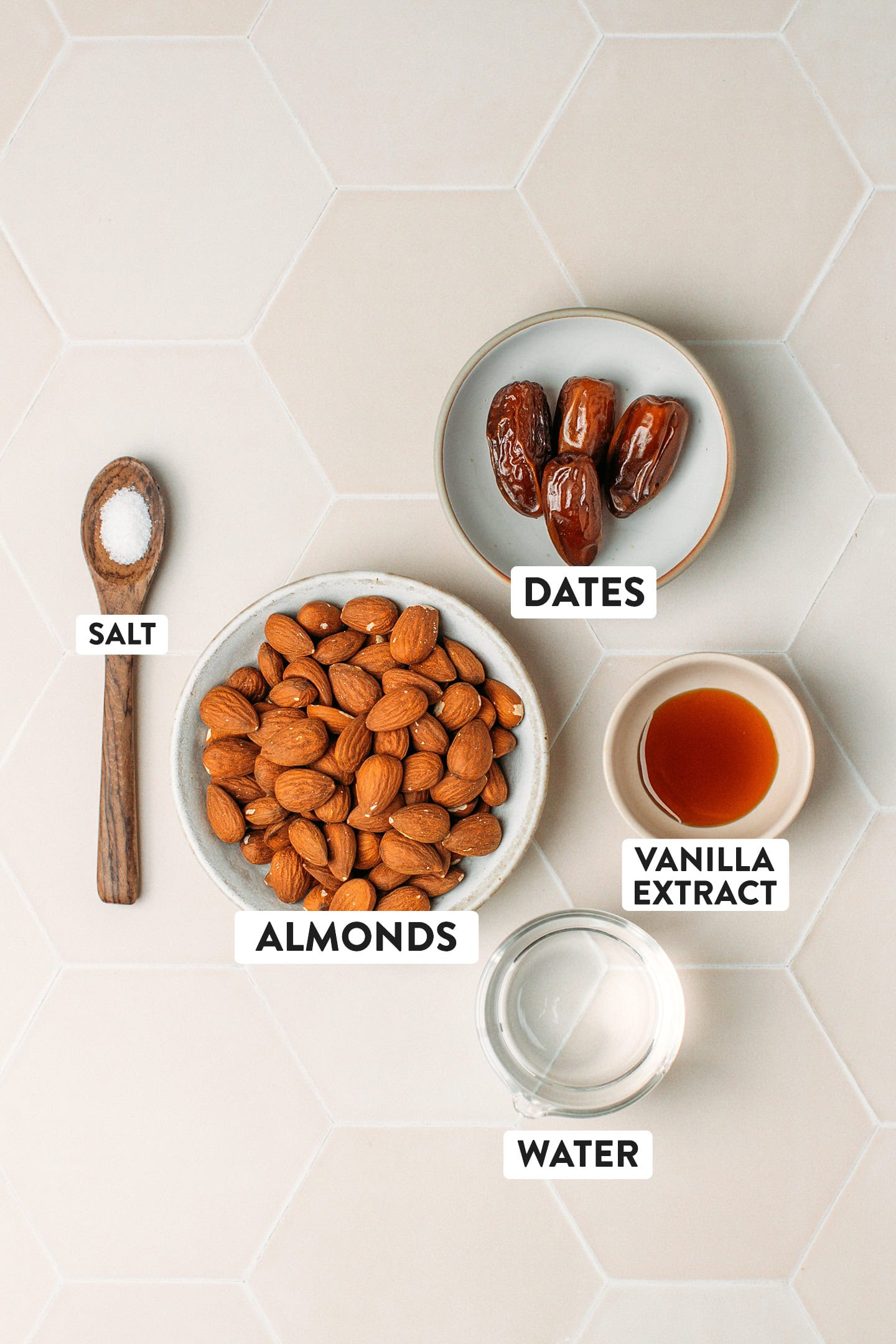 Ingredients like almonds, dates, vanilla extract, salt, and water.