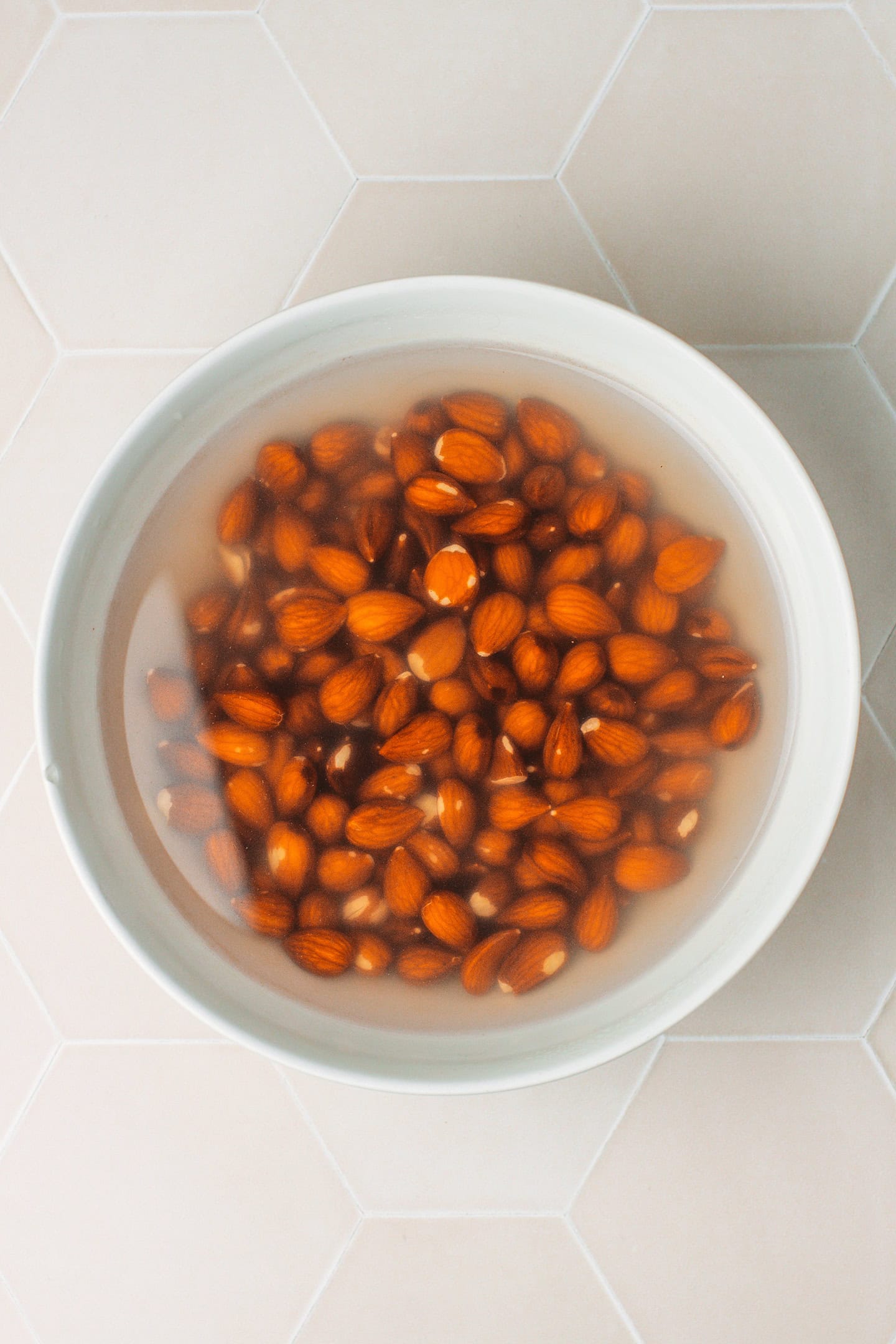 Soaked almonds in a large bowl.