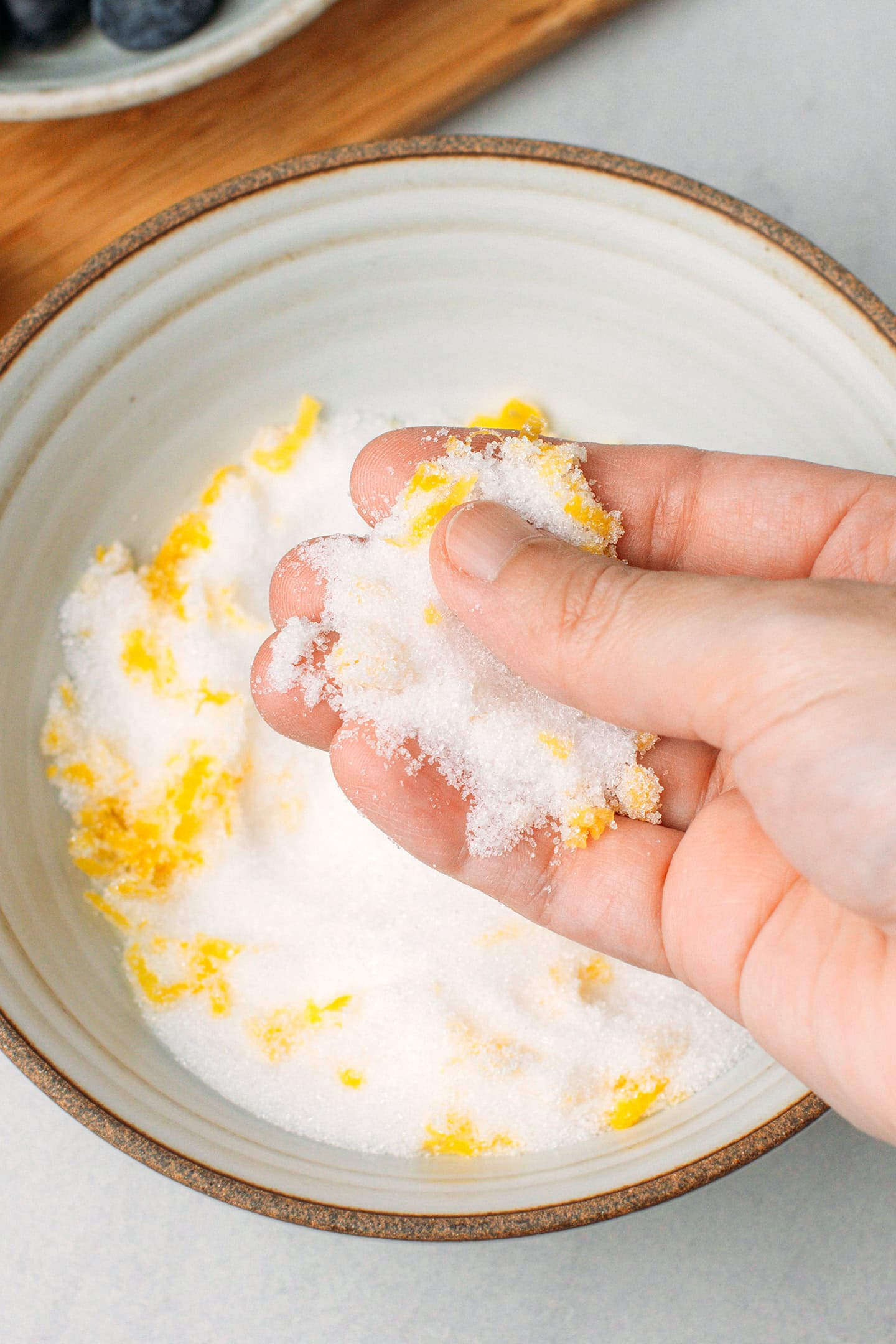 Rubbing sugar with lemon zest.