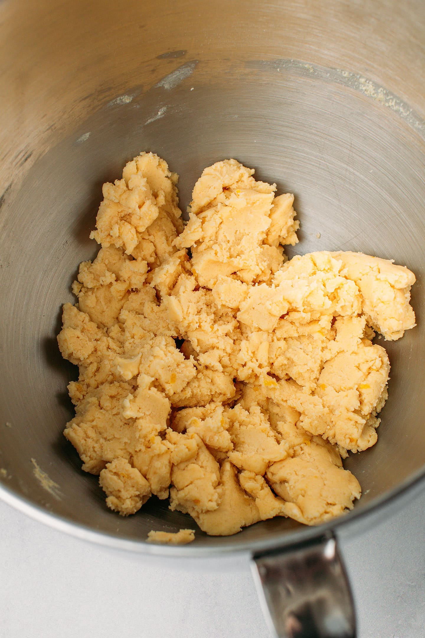 Shortbread dough in a stand mixer bowl.