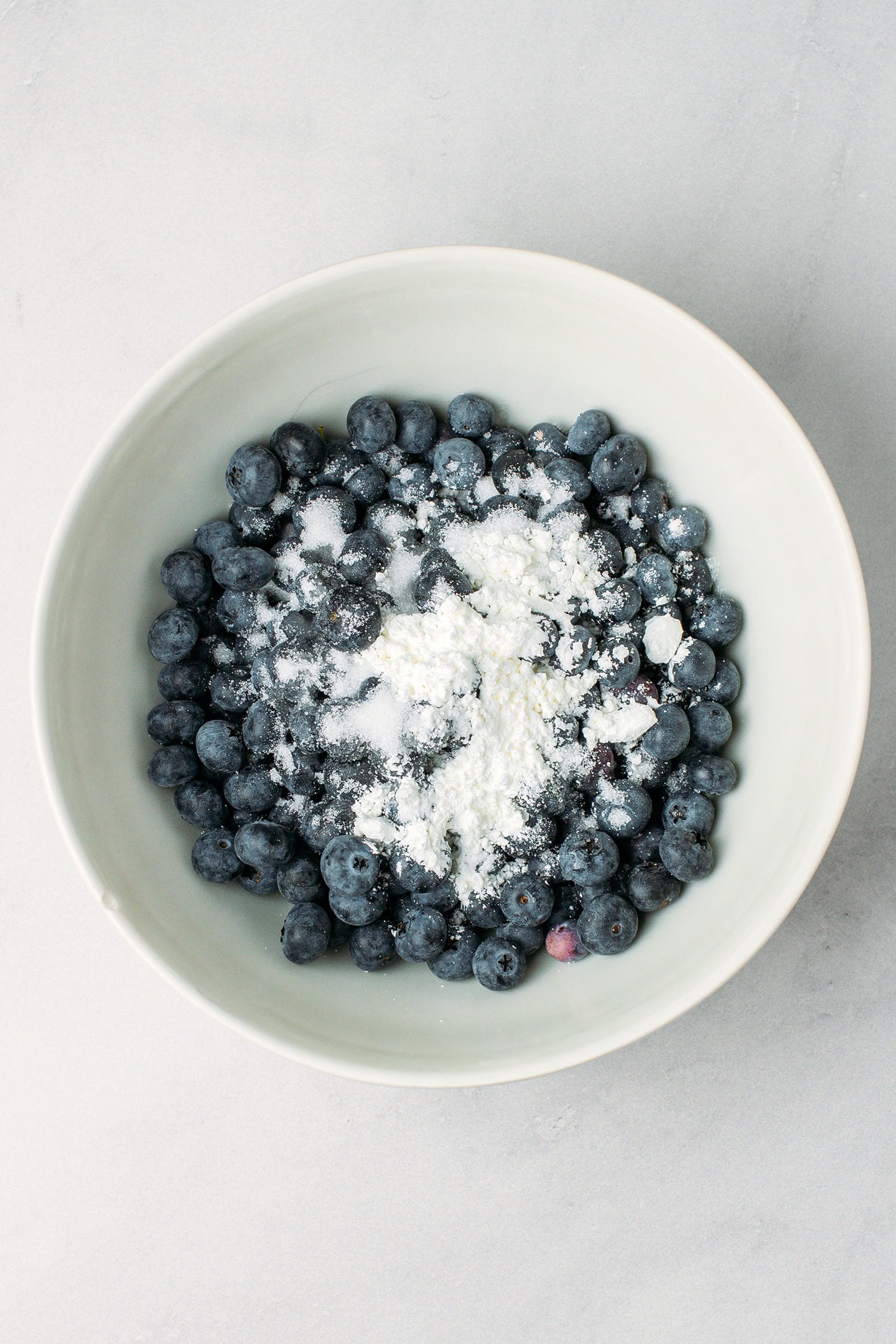 Blueberries and cornstarch in a mixing bowl.