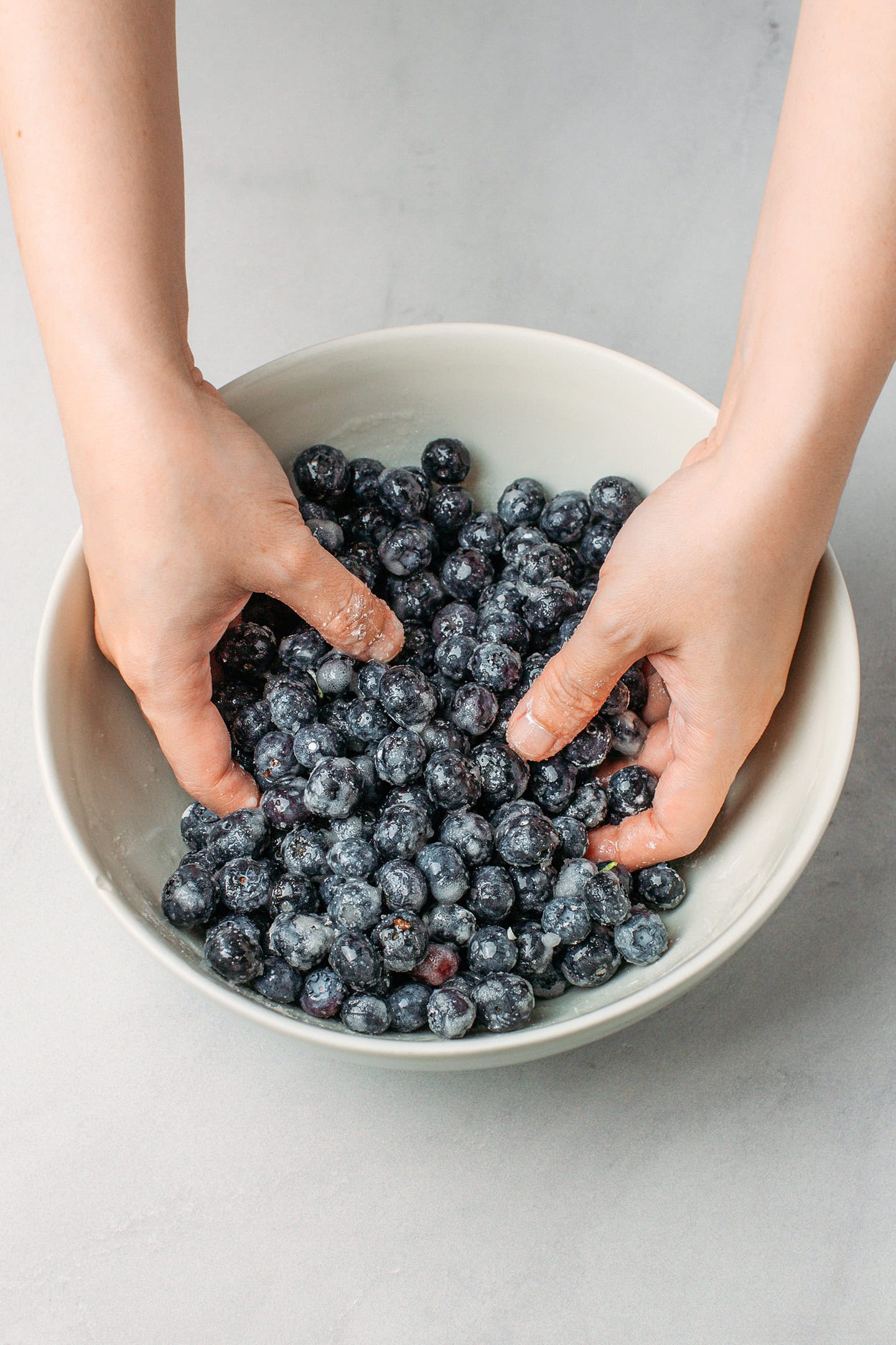 Tossing blueberries with cornstarch and lemon juice.