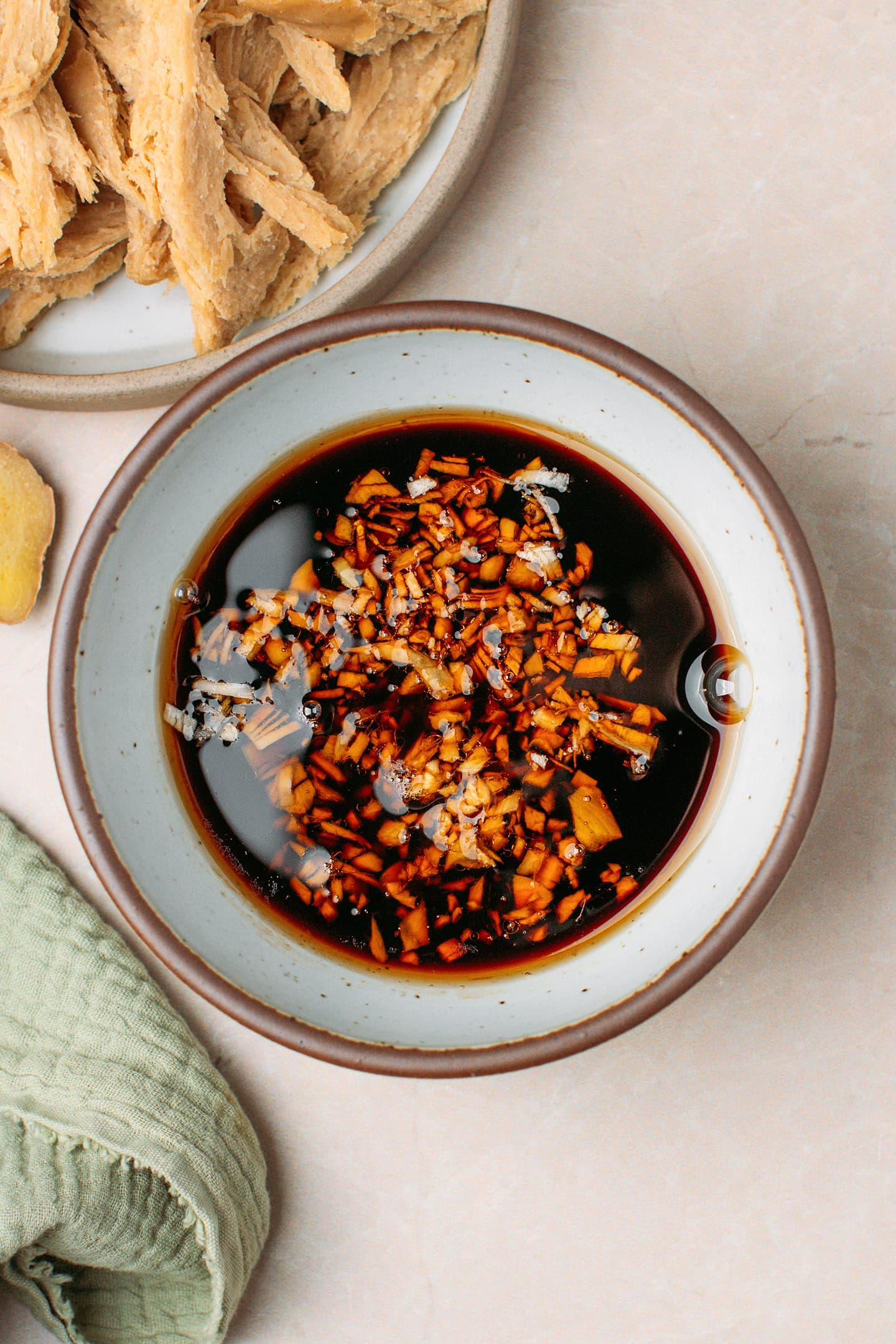 Soy sauce, maple syrup, garlic, and ginger in a small bowl.