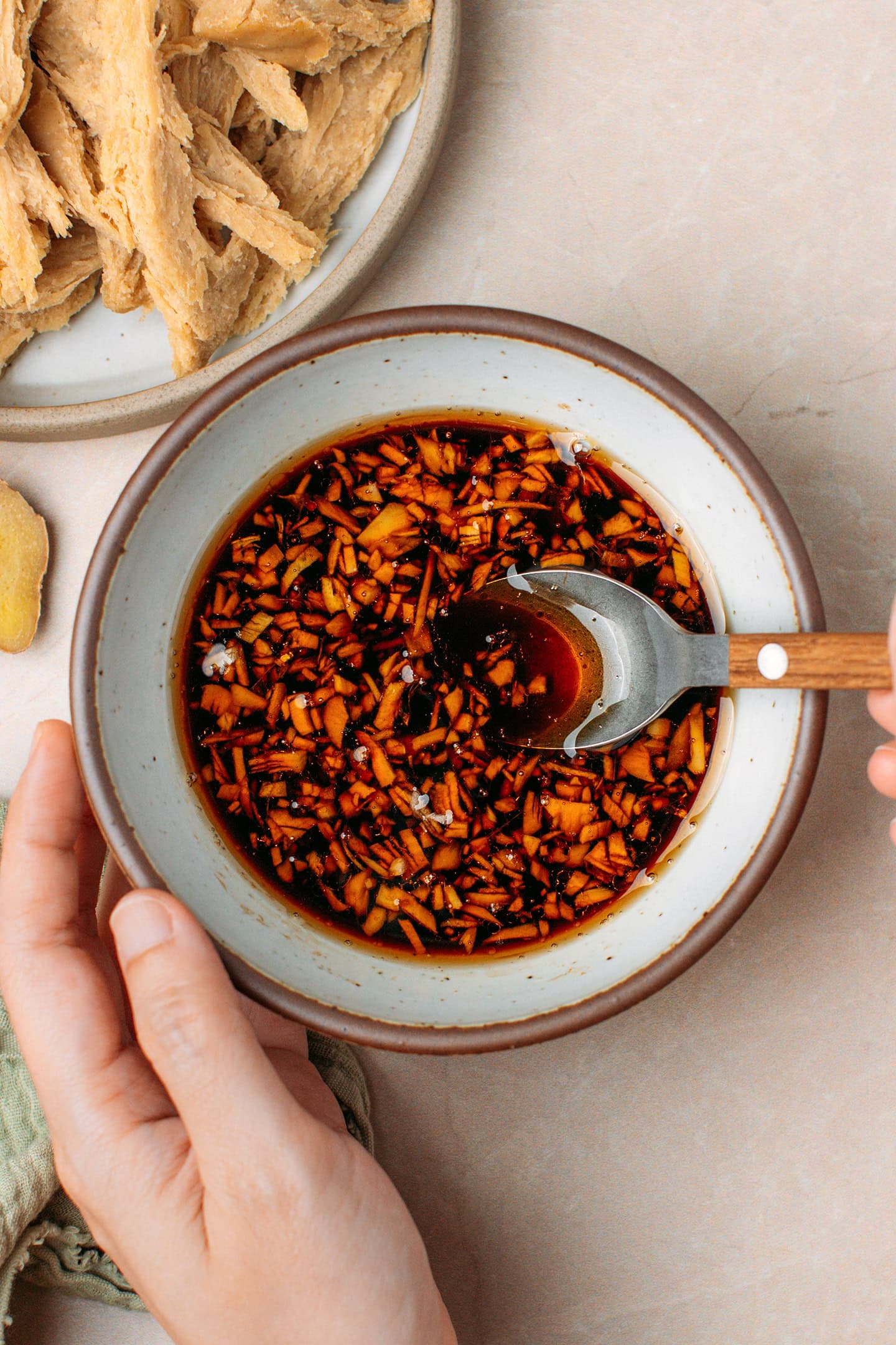 Stirring teriyaki marinade in a small bowl.