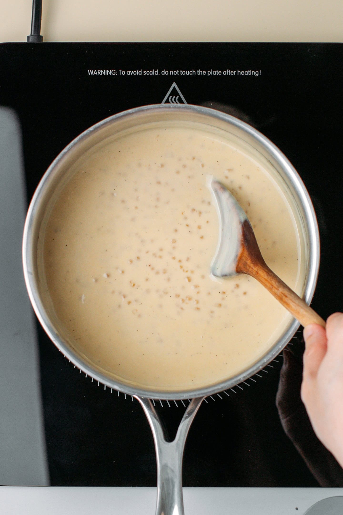 Cooking tapioca pearls with milk in a pot.