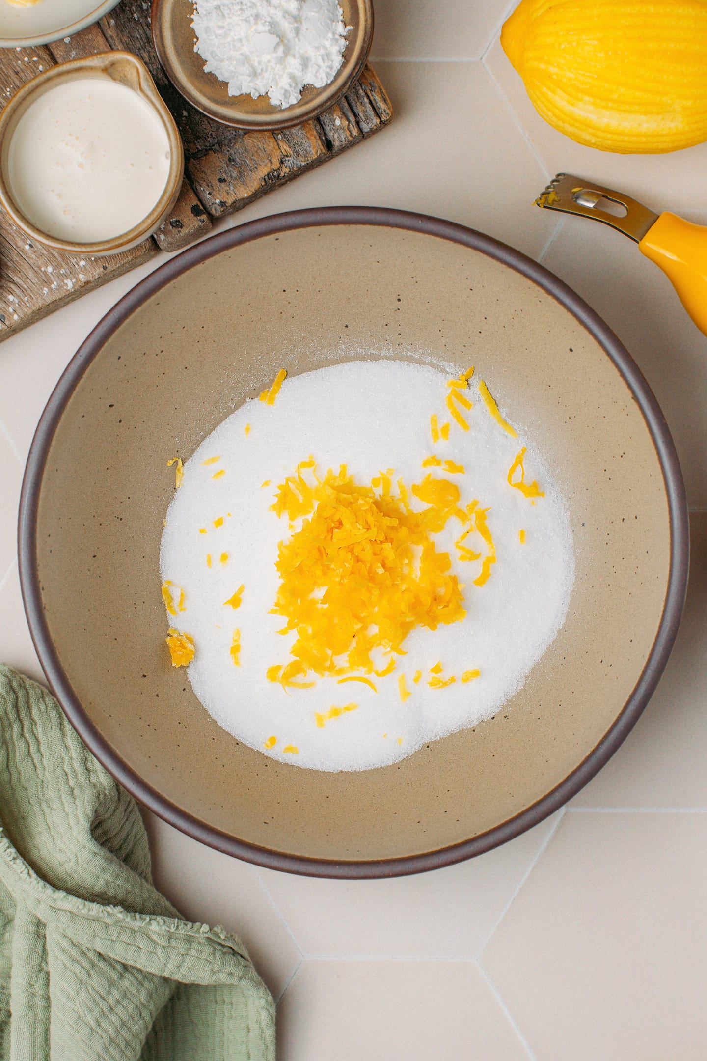 Sugar and lemon zest in a bowl.
