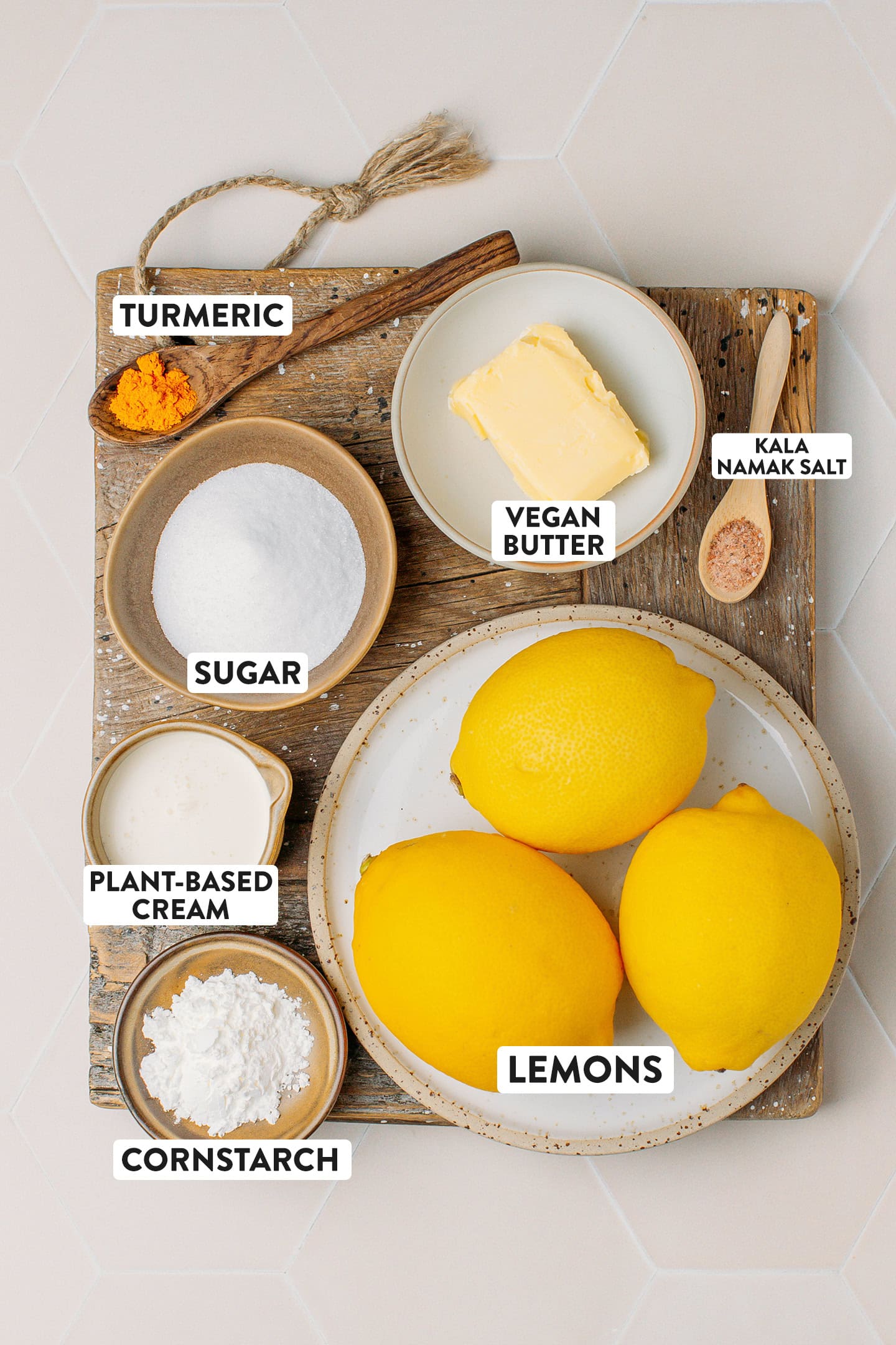 Ingredients like lemons, vegan butter, plant-based cream, cornstarch, and sugar.