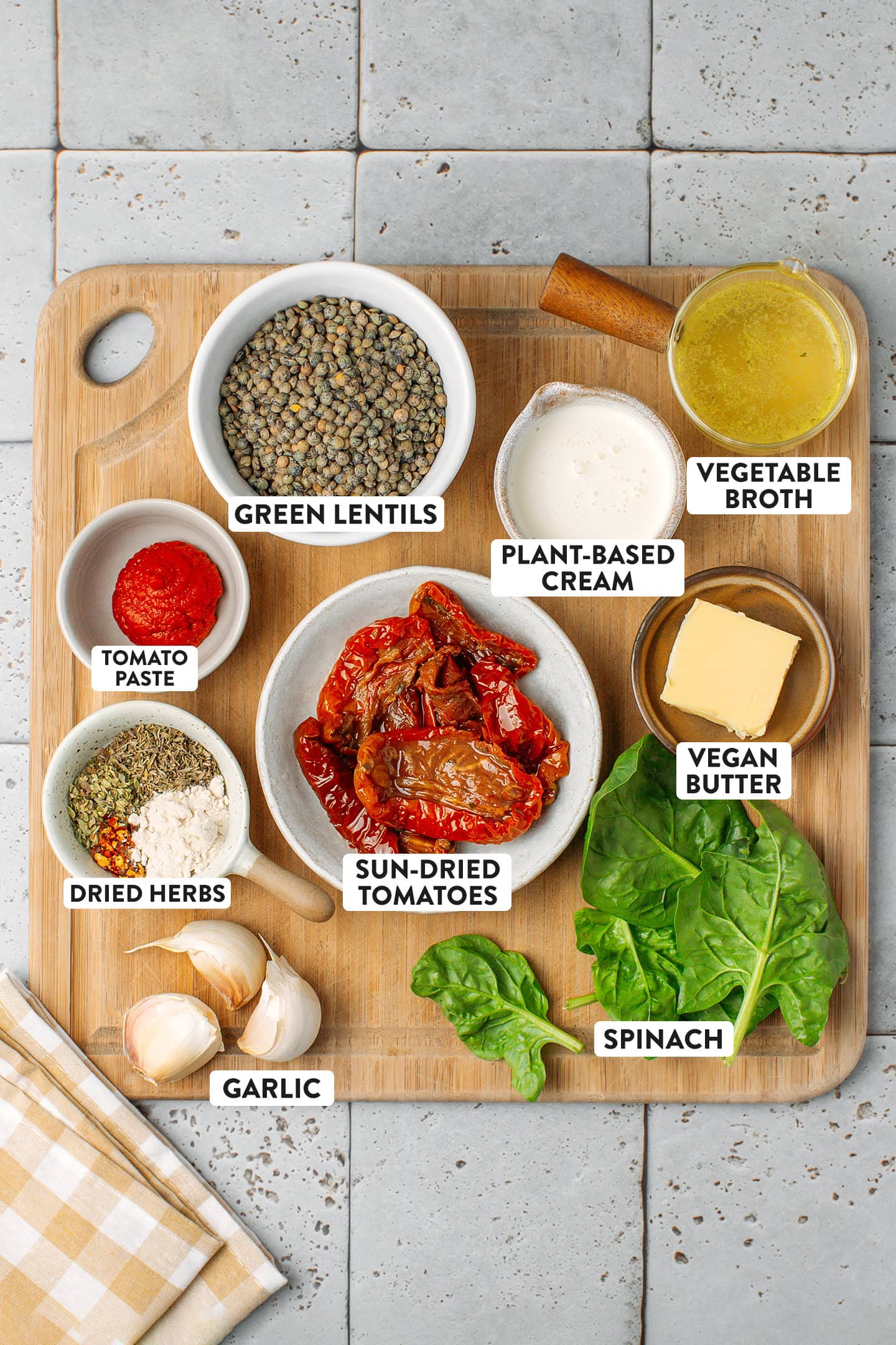 Ingredients like green lentils, spinach, sun-dried tomatoes, and garlic.