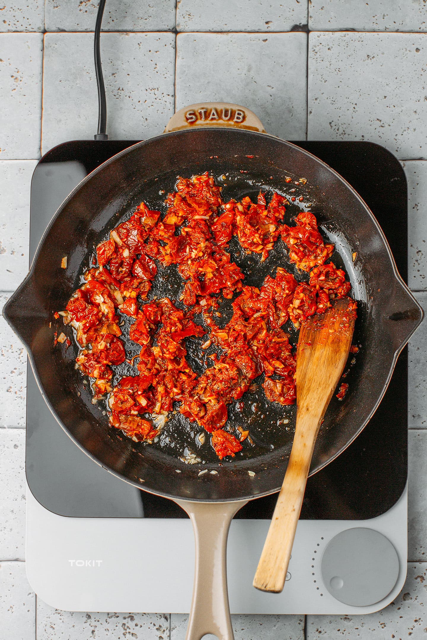 Sautéed sun-dried tomatoes in a skillet.