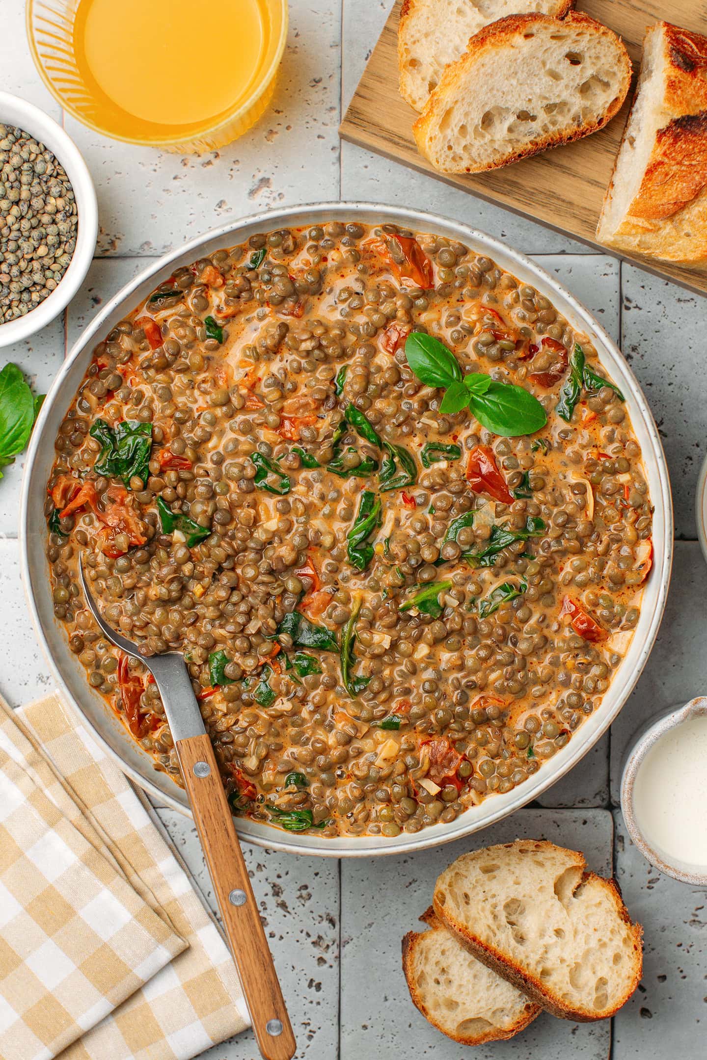 Bowl of Marry Me lentils topped with fresh basil.