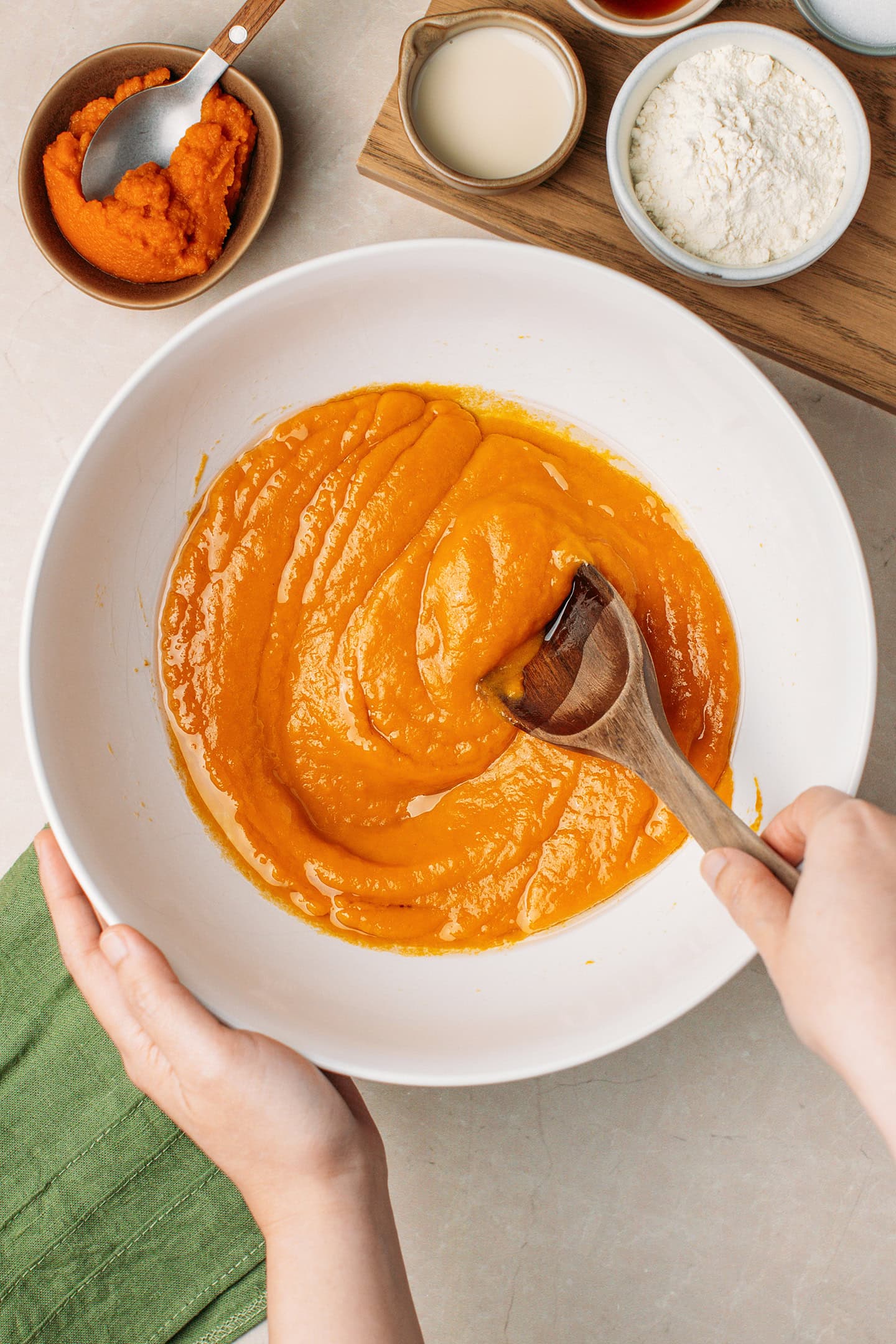 Mixing pumpkin purée with oil and milk.